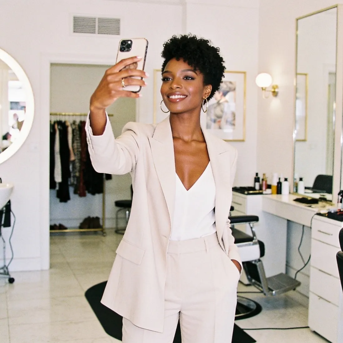 A salon owner capturing her work on her phone