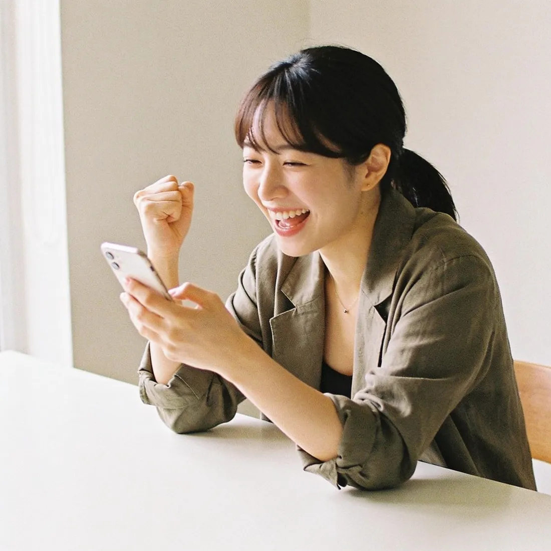 A creator celebrating a posting streak on her phone